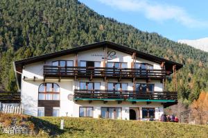 a large building with a balcony on a hill at Landhaus Linser in Tarrenz