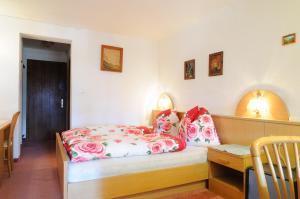 a bedroom with a bed and a table and a chair at Landhaus Linser in Tarrenz