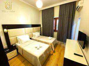 TV a/nebo společenská místnost v ubytování Hotel Vila e Arte City Center