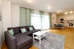 a living room with a couch and a table at Spacious Terrace Apt in Modern Klosterneuburg Building in Klosterneuburg