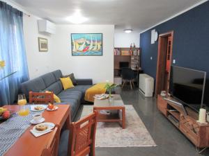 a living room with a couch and a tv at Apartment Andrea in Orebić