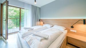 Posteľ alebo postele v izbe v ubytovaní Apartamenty Sun & Snow Resort Karkonosze