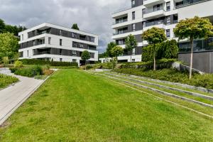 an empty lawn in front of a building at LTC Apartments Silva in Gdynia