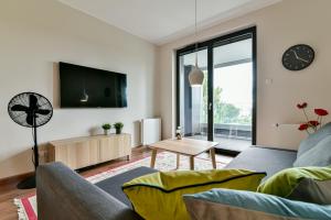 a living room with a couch and a tv at LTC Apartments Silva in Gdynia