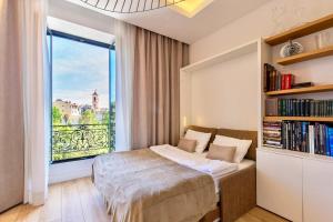a bedroom with a bed and a large window at GRAND HÔTEL City Center at 2 minutes walk from the beach in Nice