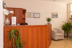 a courtroom with a wooden desk and a chair at Amon Ra Hotel in Sozopol