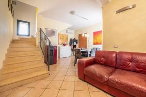 a living room with a couch and a staircase at Casa Rebecca in Settimo San Pietro