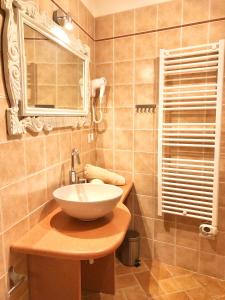 a bathroom with a sink and a mirror at San Michele delle grotte BnB in Gravina in Puglia +37 photos