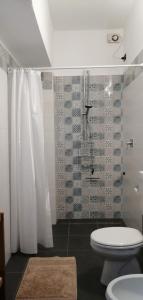 a bathroom with a white toilet and a shower at Villa Magnolia BB, Lago Maggiore (Massino Visconti, Italy) in Massino Visconti