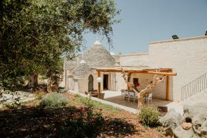 an outside view of a house with a patio at Antica tenuta dei trulli in Alberobello