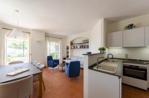 a kitchen and living room with a table and a dining room at JOIVY Villa with Splendid View and Private Garden in Mulinetti in Recco