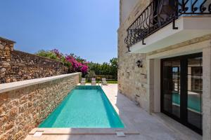 a swimming pool in the backyard of a house at Atrium Taş Otel in Çeşme