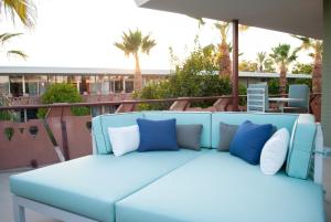 a white bed with blue pillows and blue pillows at Hotel Valley Ho in Scottsdale