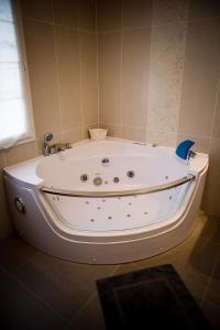 a white bath tub in a bathroom with a window at Les Gîtes du Chateau de la Morinière in Beaupréau