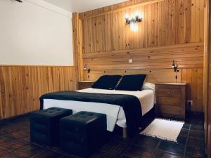 a bedroom with a large bed with wooden walls at Agroturismo Kostegi in Urnieta