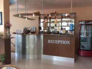 a bar in a restaurant with a sign that reads reception at Family hotel Dramchev in Nesebar