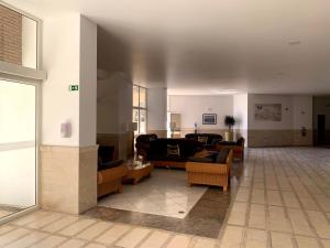 a living room with couches and chairs in a building at Discovery Apartment Vilamoura in Vilamoura