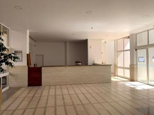a lobby with a counter in a building with windows at Discovery Apartment Vilamoura in Vilamoura +37 photos