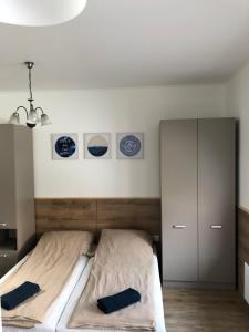 a bedroom with a bed with three plates on the wall at Avas Apartman in Miskolc