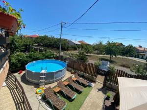 a group of chairs and a swimming pool at Iorga's House in Eforie Nord