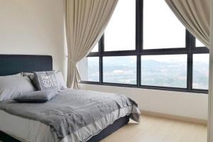 a bedroom with a bed with a large window at Dsara Sentral New Design unit 2 bedroom in Shah Alam