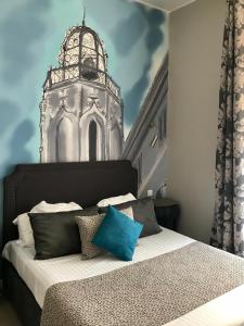 a bedroom with a large bed with a clock tower at Hôtel des Augustins in Aix-en-Provence