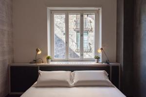 sypialnia z łóżkiem i oknem w obiekcie PONTE VECCHIO LUXURY AND STYLISH APARTMENT we Florencji