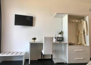 a room with a desk and a table and a chair at Bonsai in Tropea