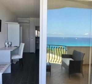 a kitchen and dining room with a view of the ocean at Bonsai in Tropea