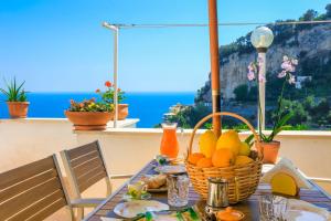 a table with a basket of fruit on a balcony at Villa Mare in Amalfi