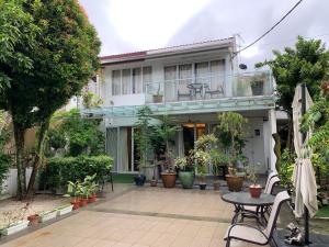 a patio in front of a house with plants at 6ix Senses Boutique Villa in Ipoh