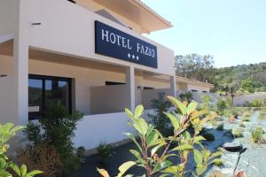 a building with a sign that reads hotel fado at Hotel Fazio in Bonifacio