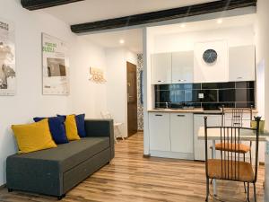 a living room with a couch and a kitchen at Old Town Studio Apartment in Toruń +5 photos