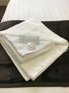 a ring is sitting on top of towels on a bed at The Feathers Hotel in Blackpool +28 photos