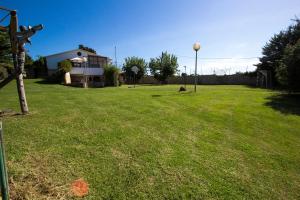 a large grass field with a house and a street light at CAN BERNARDI in Vidreres