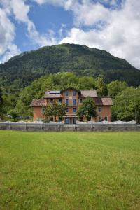 a large house in front of a mountain at Dolomitiloungebelluno Mountain Stay in Belluno