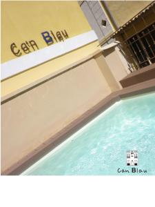 a pool of water with a sign on the side of a building at Can Blau Homes Turismo de Interior in Palma de Mallorca