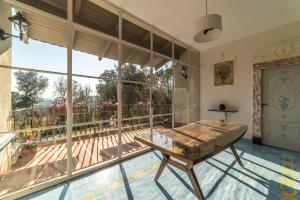 a room with a table and a large window at Villa Ortensia D'Avalos in Alvignano