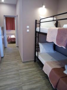 A bed or beds in a room at Athanasia inn II