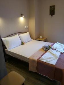 A bed or beds in a room at Athanasia inn II