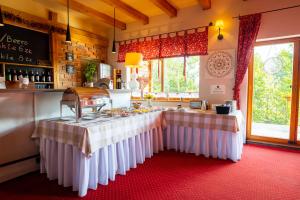 a kitchen with a table with a stove in it at Czarna Owca in Istebna