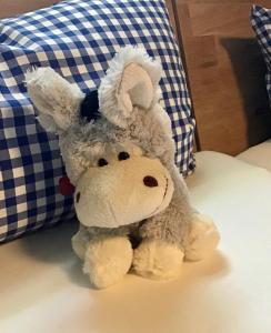 a stuffed animal is sitting on a bed at Haus Buuck - Herberge in Rüthen