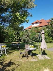 a garden with a table and chairs and a umbrella at Xotel in Xanten