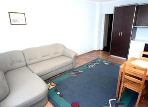 a living room with a couch and a rug at Leniuchowo in Junoszyno +5 photos