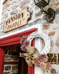 a sign on a door with a wreath on it at Pension Anapli in Nafplio