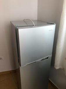 a refrigerator in a kitchen with its door open at Hotel villa Petro Dhërmi in Dhërmi