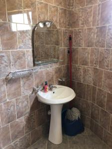 a bathroom with a sink and a mirror at Hotel villa Petro in Dhërmi