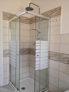 a shower with a glass door in a bathroom at Casa Marcella in Dorgali