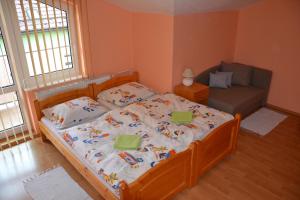 Penzion Chalupka في شتربا: غرفة نوم صغيرة مع سرير وأريكة