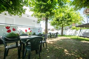 a group of tables and chairs in a yard at Antonia Rooms in Skala Fourkas
